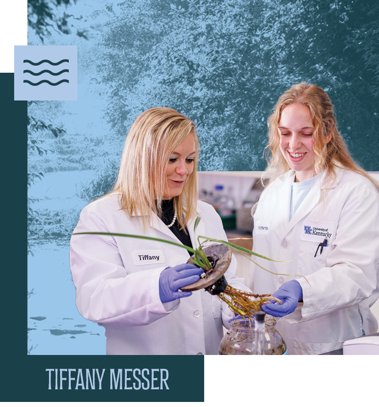 Tiffany Messer and a student inspecting a plant's roots